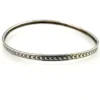 Eight-inch sterling silver crescent-pattern bangle showing its slightly irregular round shape