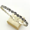 Vintage Beau sterling silver bangle with alternating hearts and dimensional flowers