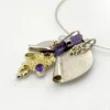 Showing sculptural depth on late 1980s Modernist sterling silver and gold-vermeil Art-to-Wear pendant necklace with amethyst, garnet and peridot