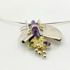 Showing double pointed amethyst crystal detail on late 1980s Modernist sterling silver and gold-vermeil Art-to-Wear pendant necklace with amethyst, garnet and peridot