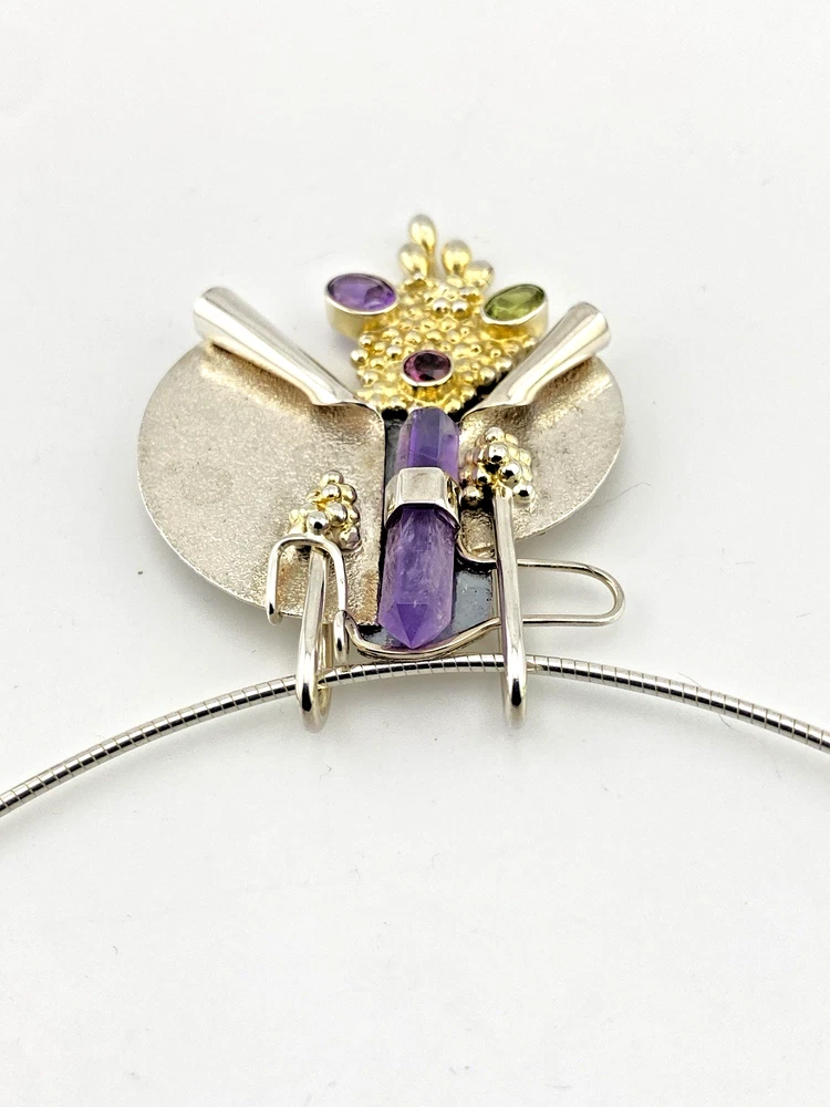 Showing sculptural depth on late 1980s Modernist sterling silver and gold-vermeil Art-to-Wear pendant necklace with amethyst, garnet and peridot view from above
