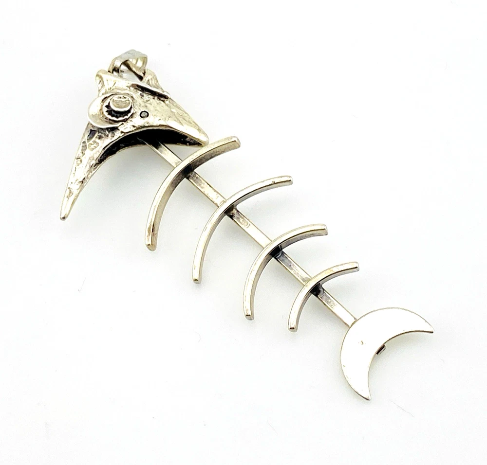 Vintage sterling silver fish skeleton pendant with cast head and articulated fabricated body