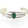 Antique Navajo sterling silver cuff bracelet with turquoise stone, hand-stamped cactus and arrow motifs, and aged silver patina, Fred Harvey era.