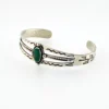 Antique Navajo sterling silver cuff bracelet with turquoise stone, hand-stamped cactus and arrow motifs, and aged silver patina, Fred Harvey era.