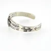 Antique Navajo sterling silver cuff bracelet with turquoise stone, hand-stamped cactus and arrow motifs, and aged silver patina, Fred Harvey era.