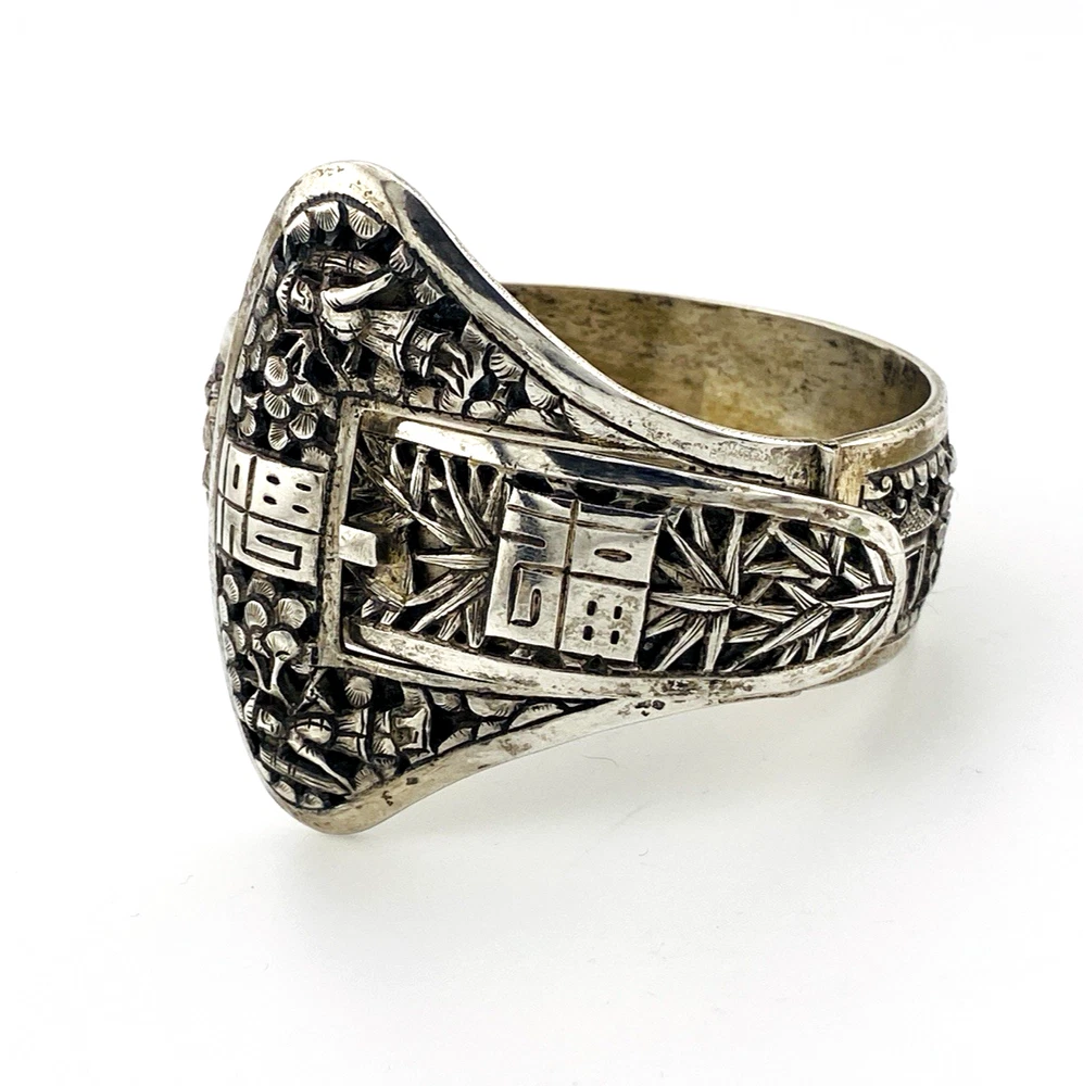 Chinese export silver buckle bracelet with pierced bamboo, flowers, figures and raised Chinese characters