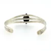 Antique Navajo sterling silver cuff bracelet with turquoise stone, hand-stamped cactus and arrow motifs, and aged silver patina, Fred Harvey era.