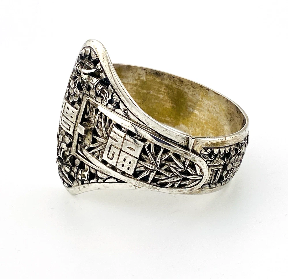 Chinese export silver buckle bracelet with pierced bamboo, flowers, figures and raised Chinese characters