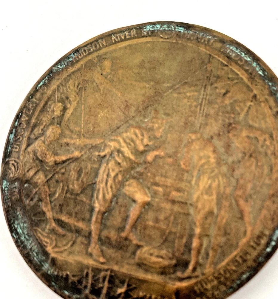 1909 Hudson-Fulton bronze medal showing Robert Fulton’s portrait above three seated allegorical women and a model steamboat.