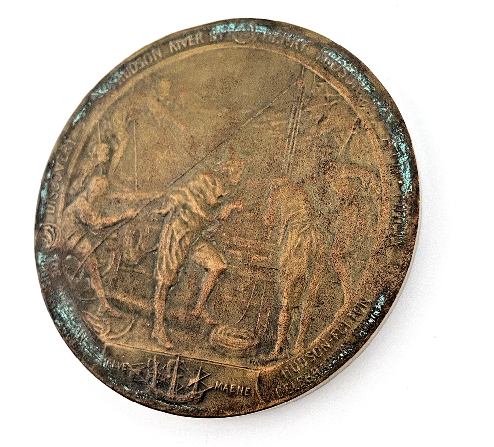 1909 Hudson-Fulton bronze medal showing Robert Fulton’s portrait above three seated allegorical women and a model steamboat.