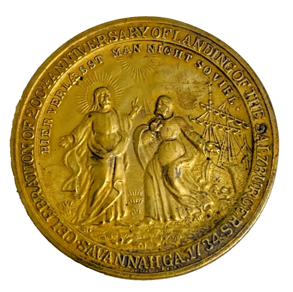 1934 United Lutheran Church bronze medal showing a religious figure facing an emigrant family beneath an angel, with Savannah convention inscriptions.