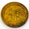 1934 United Lutheran Church bronze medal showing a religious figure facing an emigrant family beneath an angel, with Savannah convention inscriptions.