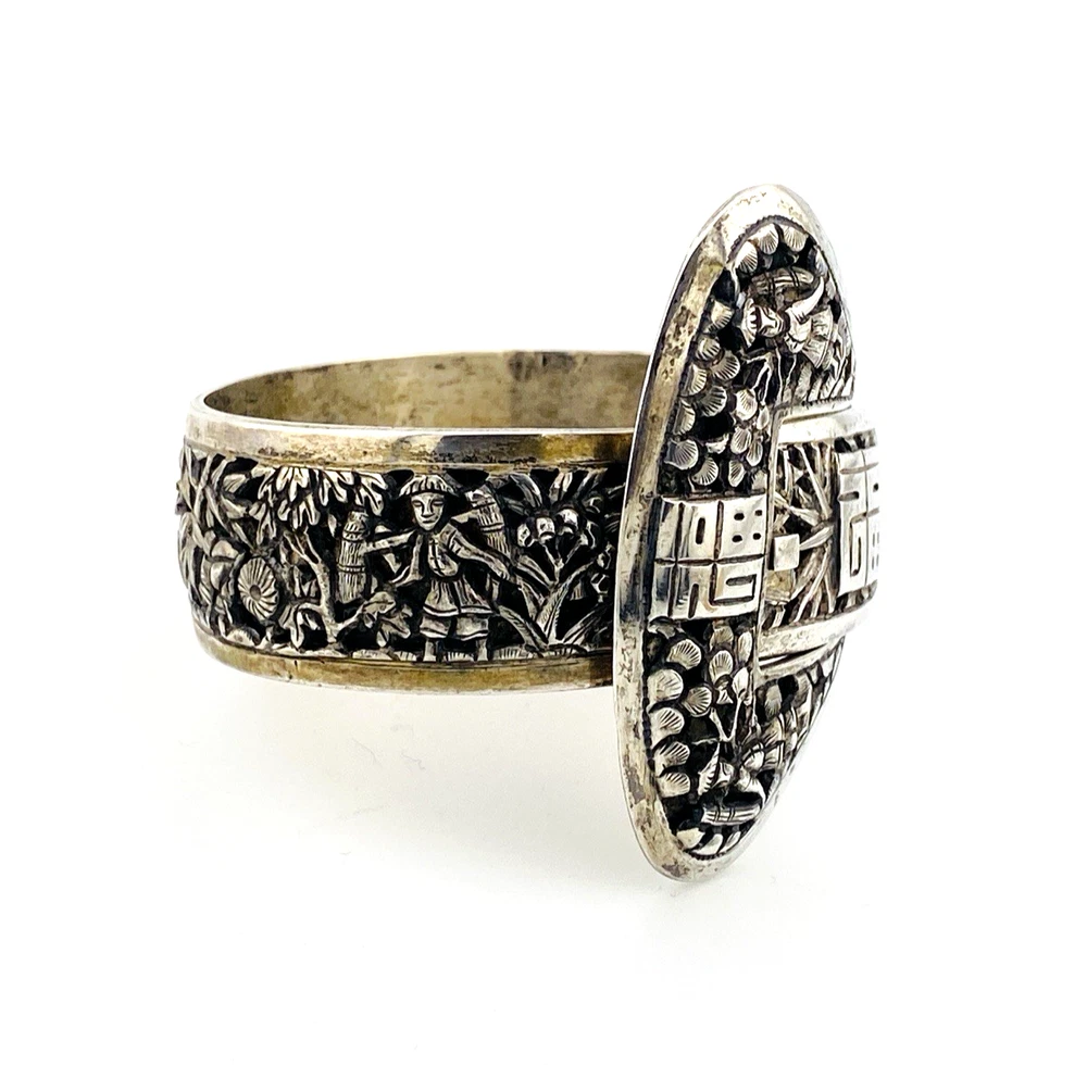 Chinese export silver buckle bracelet with pierced bamboo, flowers, figures and raised Chinese characters