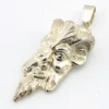 Sterling silver pendant showing a bearded mythological figure with curled ram horns, an acanthus leaf between the horns, a pointed beard, and a broad bail.