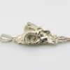 Sterling silver pendant showing a bearded mythological figure with curled ram horns, an acanthus leaf between the horns, a pointed beard, and a broad bail.