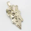 Sterling silver pendant showing a bearded mythological figure with curled ram horns, an acanthus leaf between the horns, a pointed beard, and a broad bail.