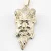 Sterling silver pendant showing a bearded mythological figure with curled ram horns, an acanthus leaf between the horns, a pointed beard, and a broad bail.