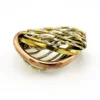 Sculptural unisex cuff bracelet with intertwined brass wires, a textured copper arc, silver-colored molten-drop accents, and rounded ball terminals.