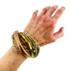 Sculptural unisex cuff bracelet with intertwined brass wires, a textured copper arc, silver-colored molten-drop accents, and rounded ball terminals.