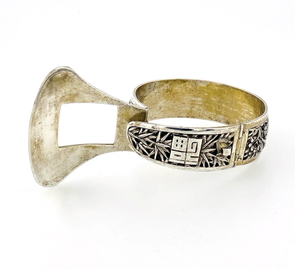 Chinese export silver buckle bracelet with pierced bamboo, flowers, figures and raised Chinese characters