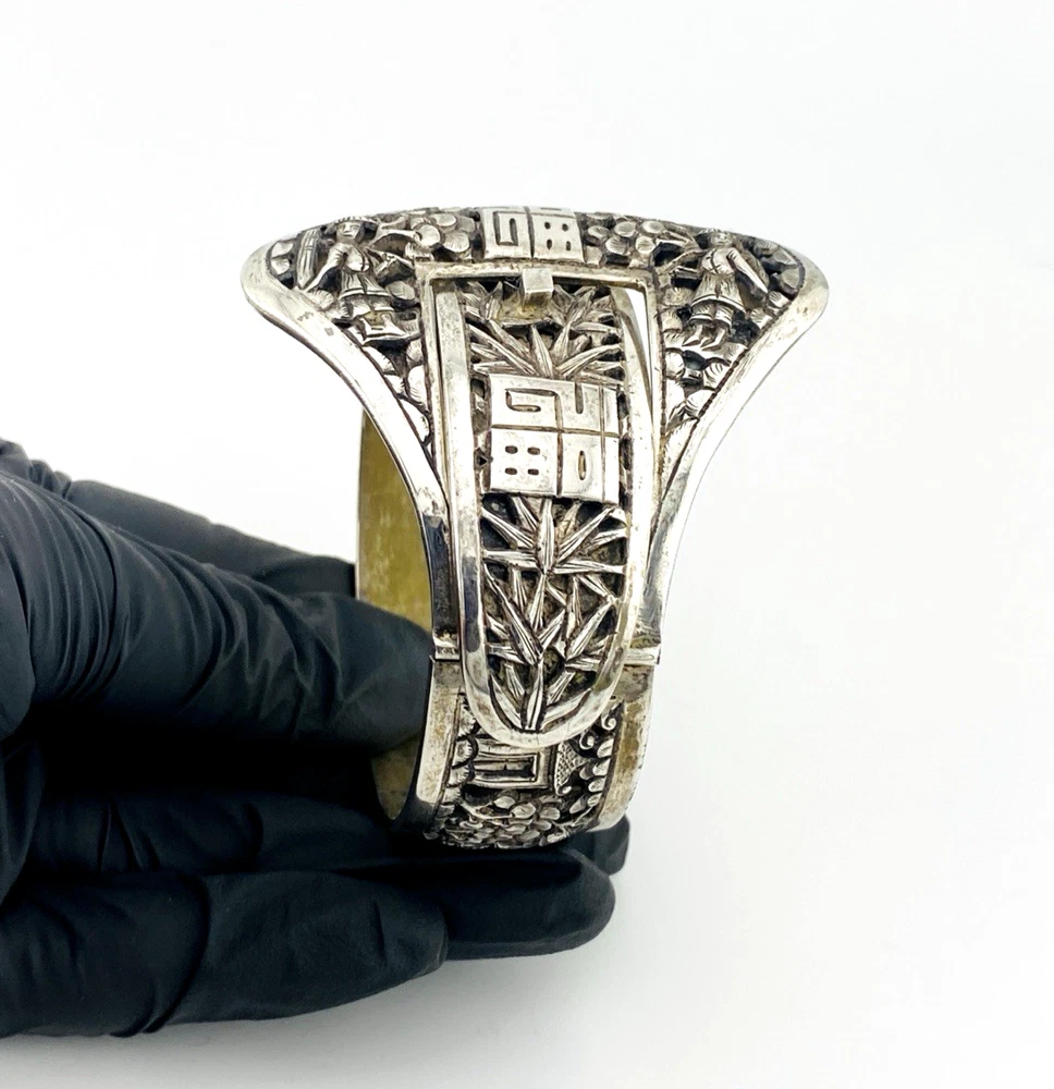 Chinese export silver buckle bracelet with pierced bamboo, flowers, figures and raised Chinese characters