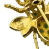Gold-plated sterling silver bee brooch with a green gemstone-set body, clear cubic zirconia accent, raised patterned wings, and textured legs.
