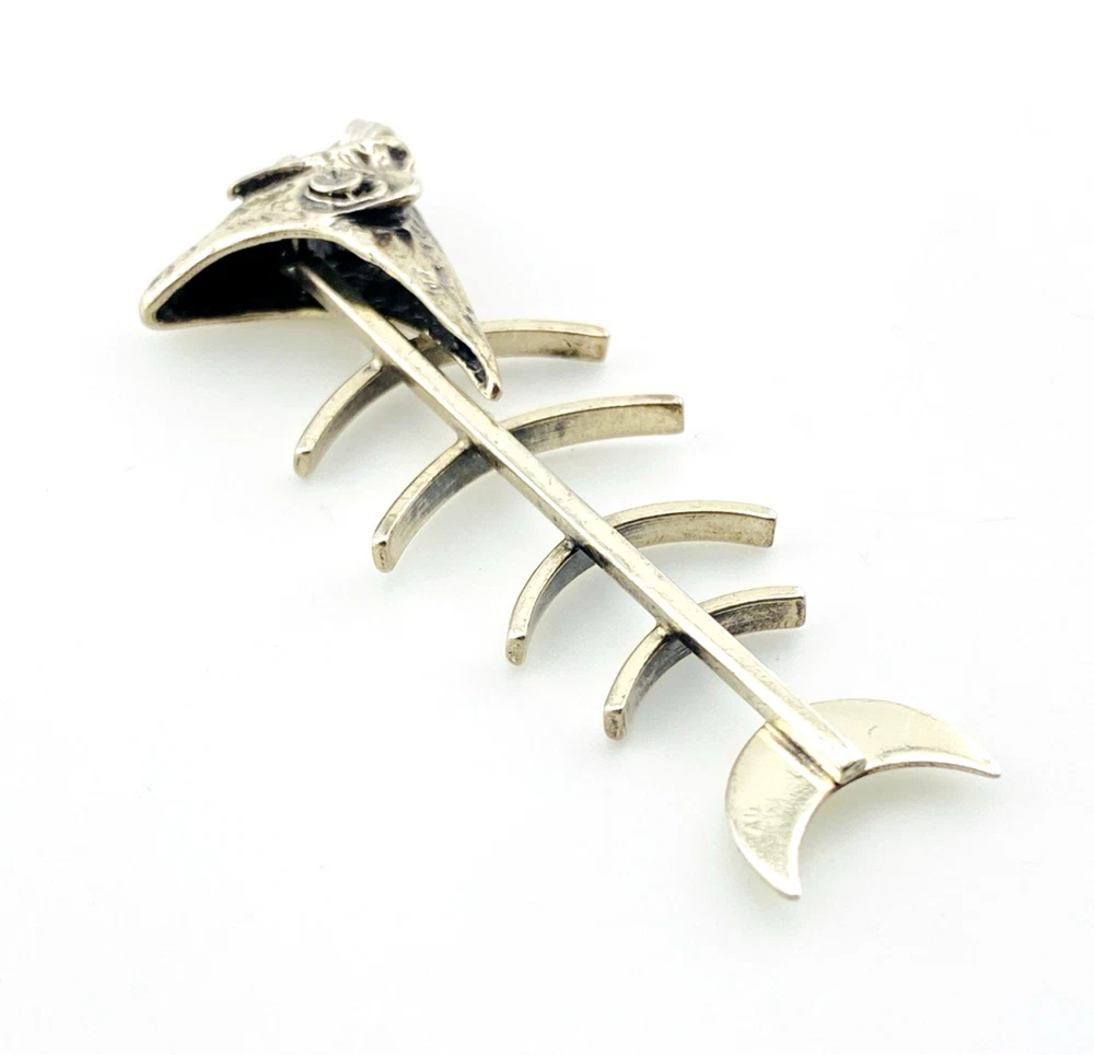 Vintage sterling silver fish skeleton pendant with cast head and articulated fabricated body