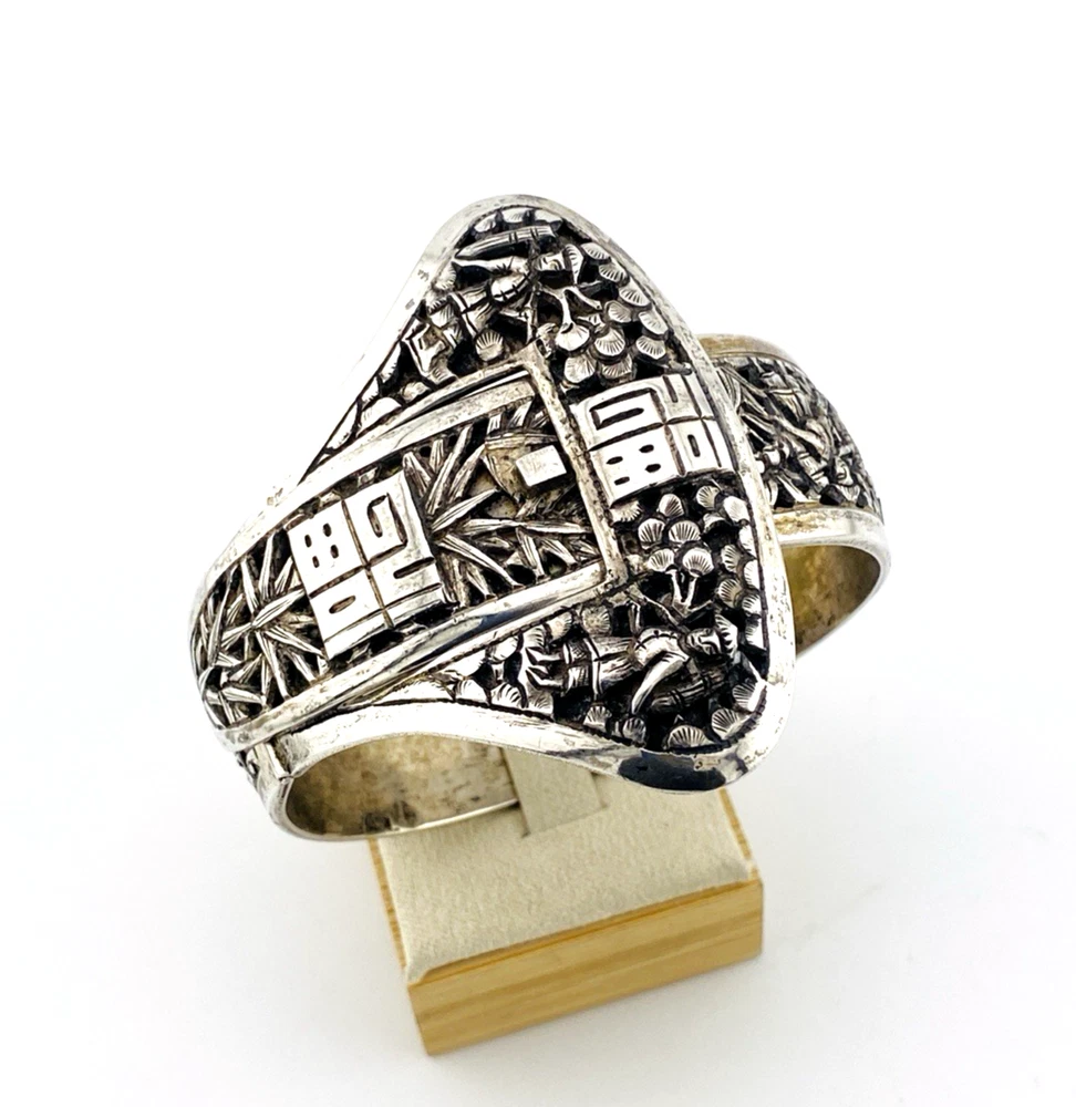 Chinese export silver buckle bracelet with pierced bamboo, flowers, figures and raised Chinese characters