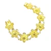 Pale gold-over-silver bracelet with eight six-petal filigree flowers, raised bead centers, and paired connecting links.