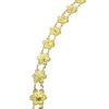 Pale gold-over-silver bracelet with eight six-petal filigree flowers, raised bead centers, and paired connecting links.