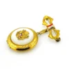 Gold-plated WWII sweetheart locket brooch with an eagle-and-shield emblem on mother of pearl, engraved border, and red, white, and blue enameled bow.