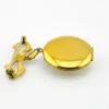 Gold-plated WWII sweetheart locket brooch with an eagle-and-shield emblem on mother of pearl, engraved border, and red, white, and blue enameled bow.