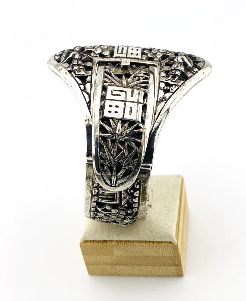 Chinese export silver buckle bracelet with pierced bamboo, flowers, figures and raised Chinese characters