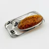 Circa 1990s sterling silver brooch with a large oval cognac amber cabochon and three calla lilies forming an open rectangular frame.