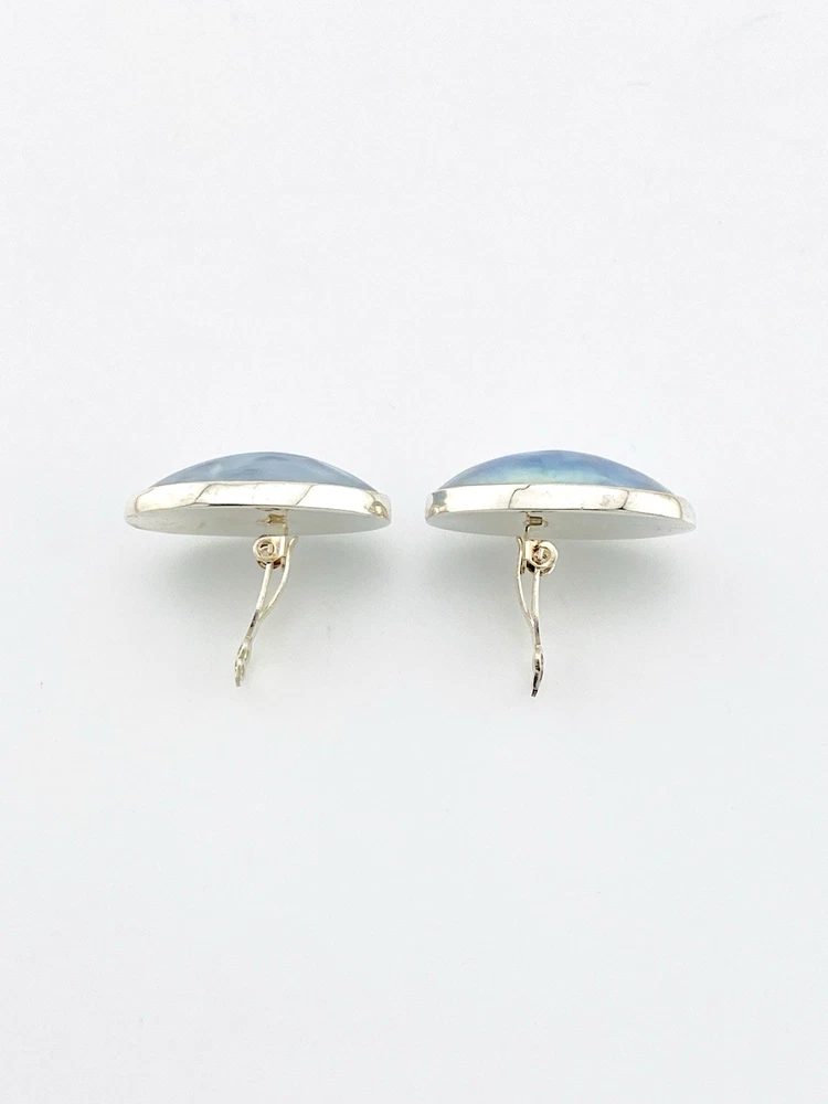 Great Falls Metal Works oval light blue mabé pearl earrings in narrow sterling silver bezels, shown upright from the front.
