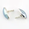 Great Falls Metal Works oval light blue mabé pearl earrings in narrow sterling silver bezels, shown upright from the front.
