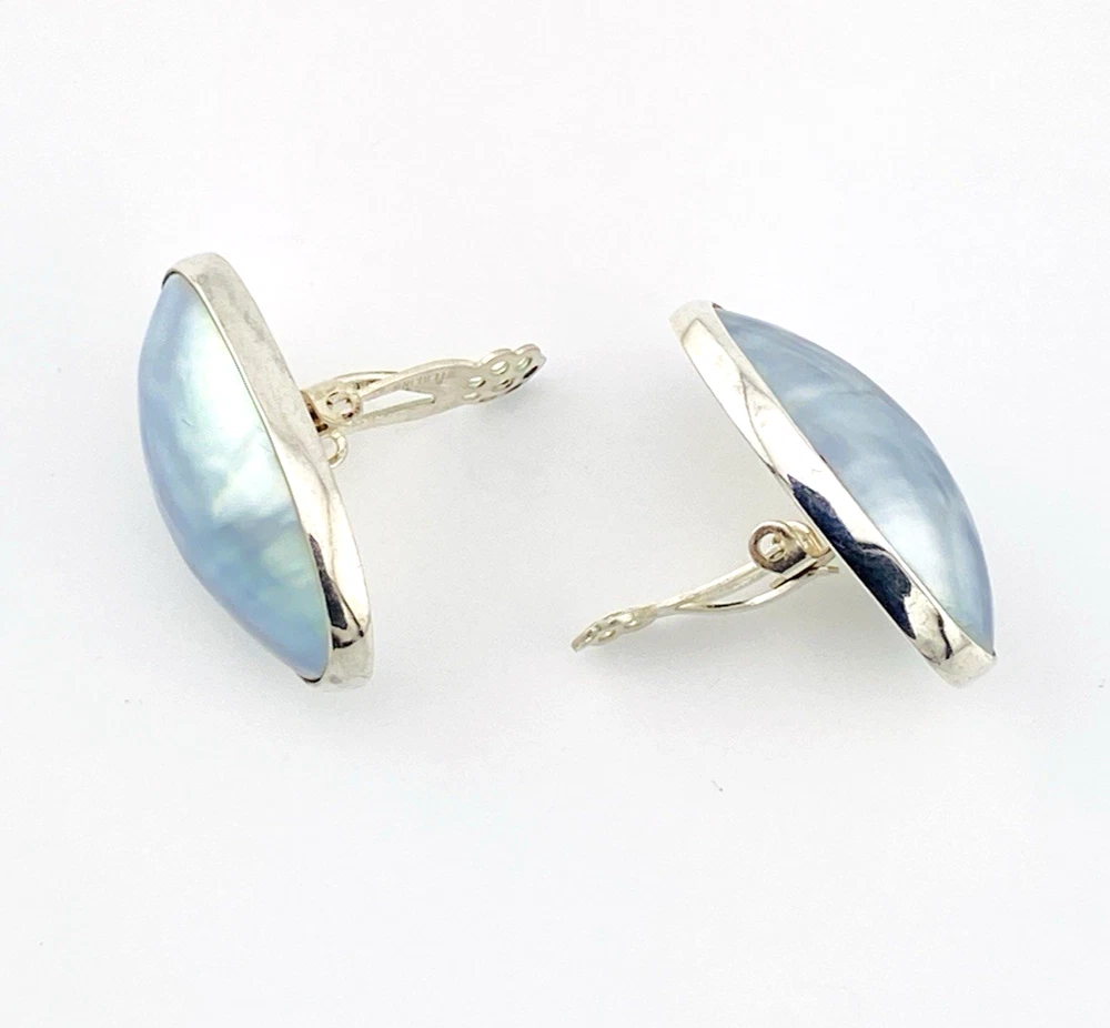 Great Falls Metal Works oval light blue mabé pearl earrings in narrow sterling silver bezels, shown upright from the front.