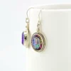 VIVAH oval mystic topaz drop earrings with purple, pink, green, and blue reflections, bordered by concentric sterling silver frames.