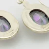 VIVAH oval mystic topaz drop earrings with purple, pink, green, and blue reflections, bordered by concentric sterling silver frames.