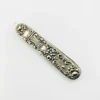 Vintage sterling silver needle case with raised cabbage roses, curling scrollwork, darkened recesses, and a suspension loop on the cap.