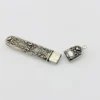 Vintage sterling silver needle case with raised cabbage roses, curling scrollwork, darkened recesses, and a suspension loop on the cap.