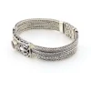 Multistrand silver bracelet with square woven chains, curved scrollwork panel, oval garnet and decorated box clasp