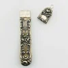 Vintage sterling silver needle case with raised cabbage roses, curling scrollwork, darkened recesses, and a suspension loop on the cap.