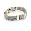 Multistrand silver bracelet with square woven chains, curved scrollwork panel, oval garnet and decorated box clasp