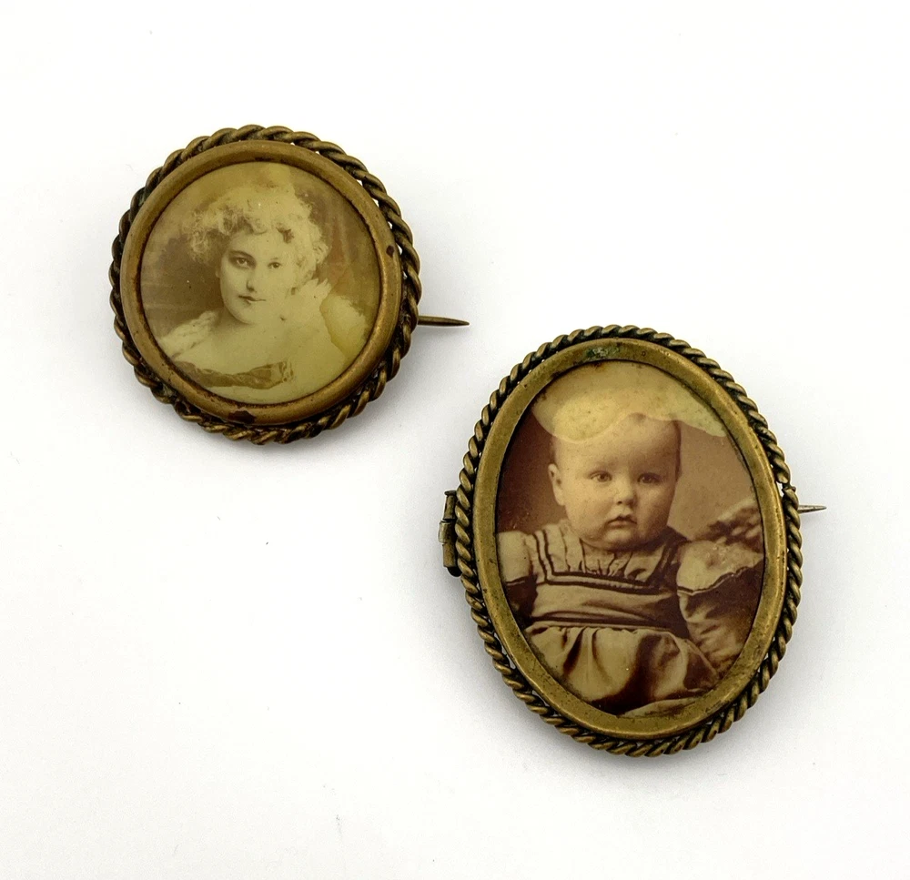 Two antique gold-tone rope-border brooches: a round faded portrait of a woman and an oval tintype portrait of a young child.