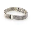Multistrand silver bracelet with square woven chains, curved scrollwork panel, oval garnet and decorated box clasp
