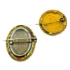 Two antique gold-tone rope-border brooches: a round faded portrait of a woman and an oval tintype portrait of a young child.