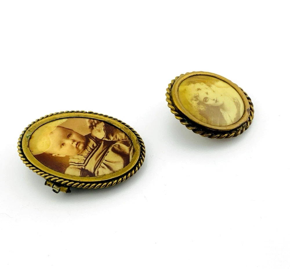 Two antique gold-tone rope-border brooches: a round faded portrait of a woman and an oval tintype portrait of a young child.