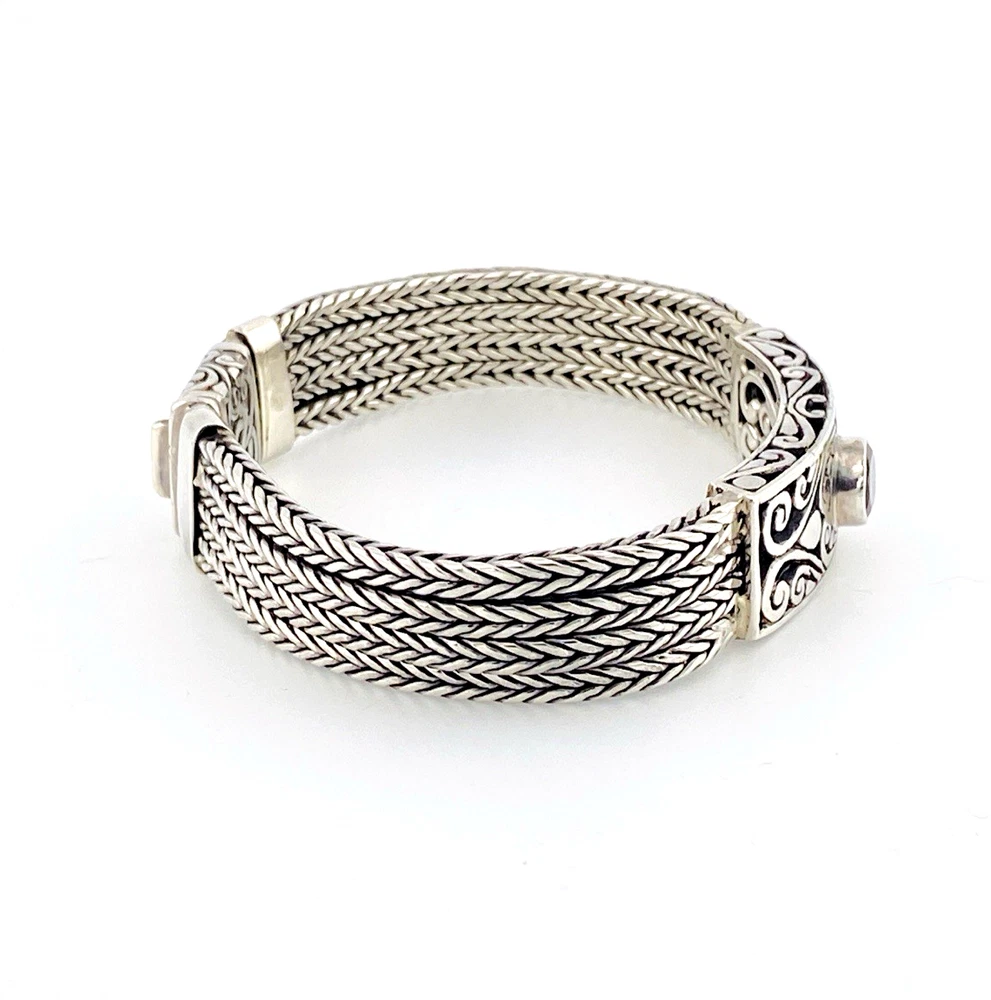 Multistrand silver bracelet with square woven chains, curved scrollwork panel, oval garnet and decorated box clasp
