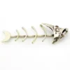 Vintage sterling silver fish skeleton pendant with cast head and articulated fabricated body